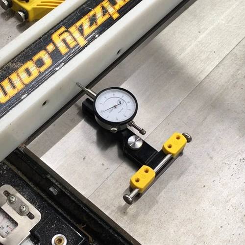 Precision universal saw indicator gauge with yellow mounts used for table saw alignment in tool and power tool accessories collections