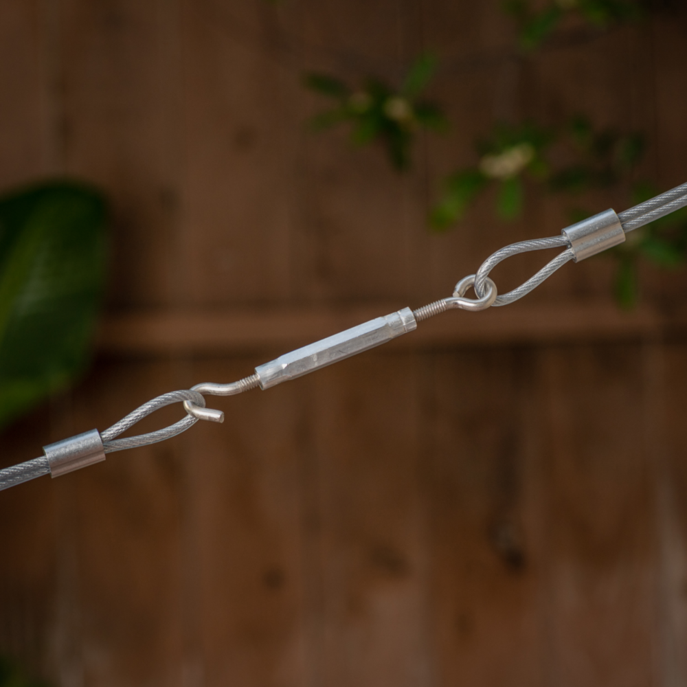 Stainless steel hook and eye turnbuckle securing cables for outdoor storage and garage organization projects