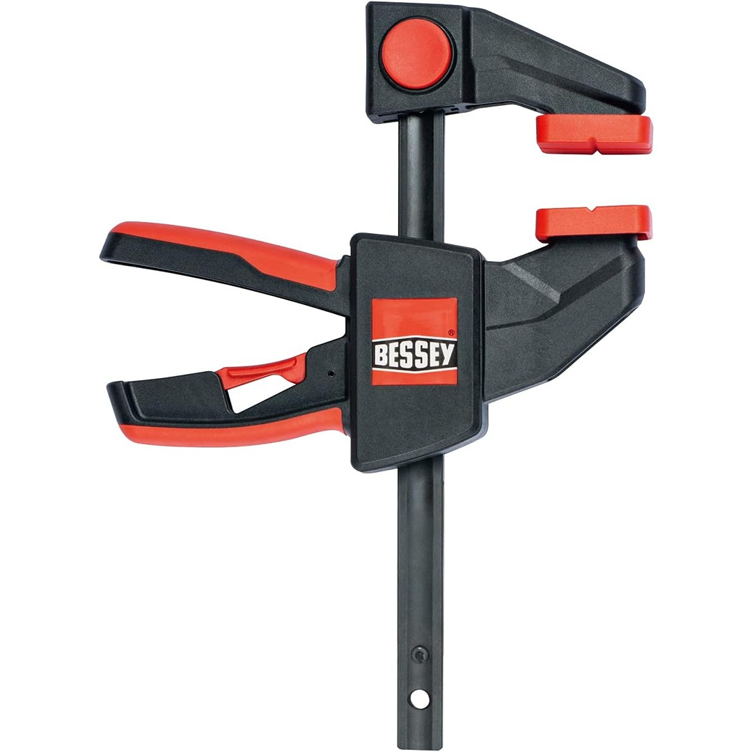 Black and red 24-inch trigger clamp with ergonomic handle for woodworking and home improvement tasks