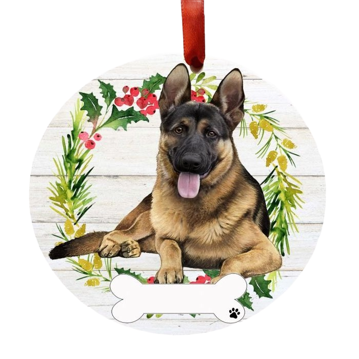 Round ornament with a happy German Shepherd resting inside a festive holly and greenery wreath with red ribbon hanger
