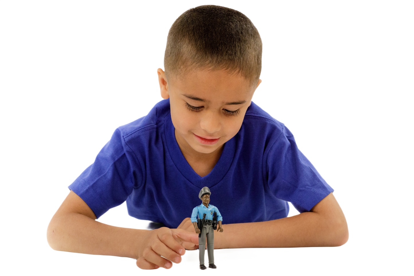 Boy in blue shirt playing with a dark-skinned policeman toy figure dressed in a detailed blue uniform and cap