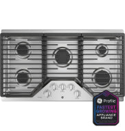 Top view of stainless steel gas cooktop with five burners and control knobs in modern kitchen setting