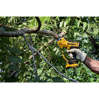 Yellow and black cordless pruning tool cutting medium tree branch for garden and outdoor hand tools use