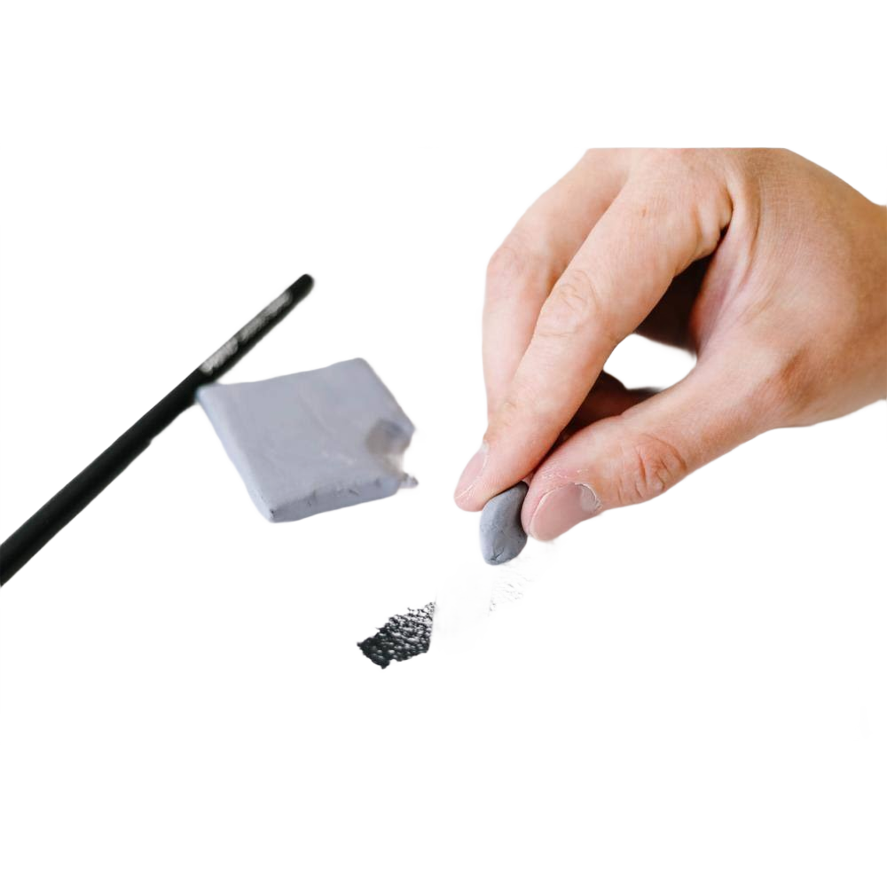 Hand holding gray kneaded eraser removing charcoal marks with pencil on white background in office supplies collection