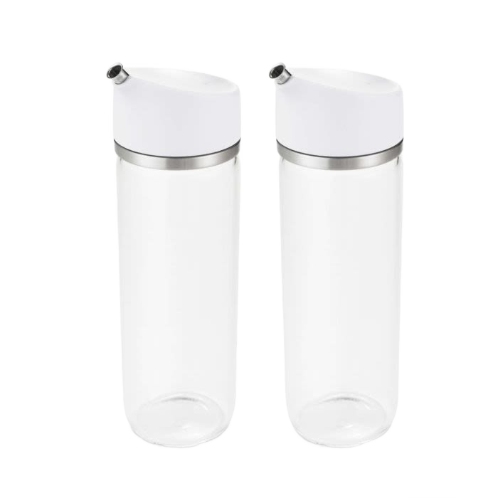Set of clear glass dispensers with white precision pour lids for oil and vinegar storage in kitchenware collections