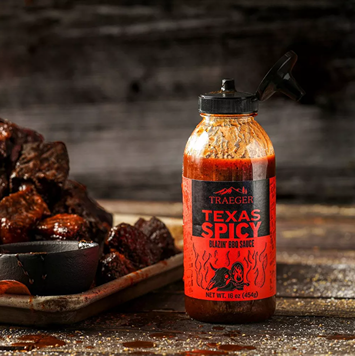 Squeeze bottle of Traeger Texas Spicy BBQ sauce with grilled meat and bowl in outdoor living and grilling sauces collections under $50