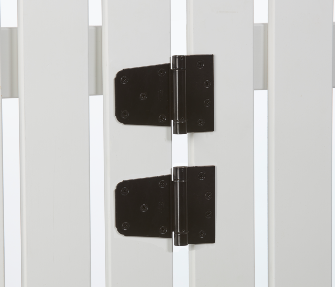 Pair of black heavy-duty gate hinges installed on white wood gate for home improvement and gate hardware projects