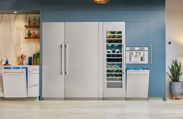 Built-in refrigerator and freezer columns with stainless steel finish and built-in wine cooler in modern kitchen setting