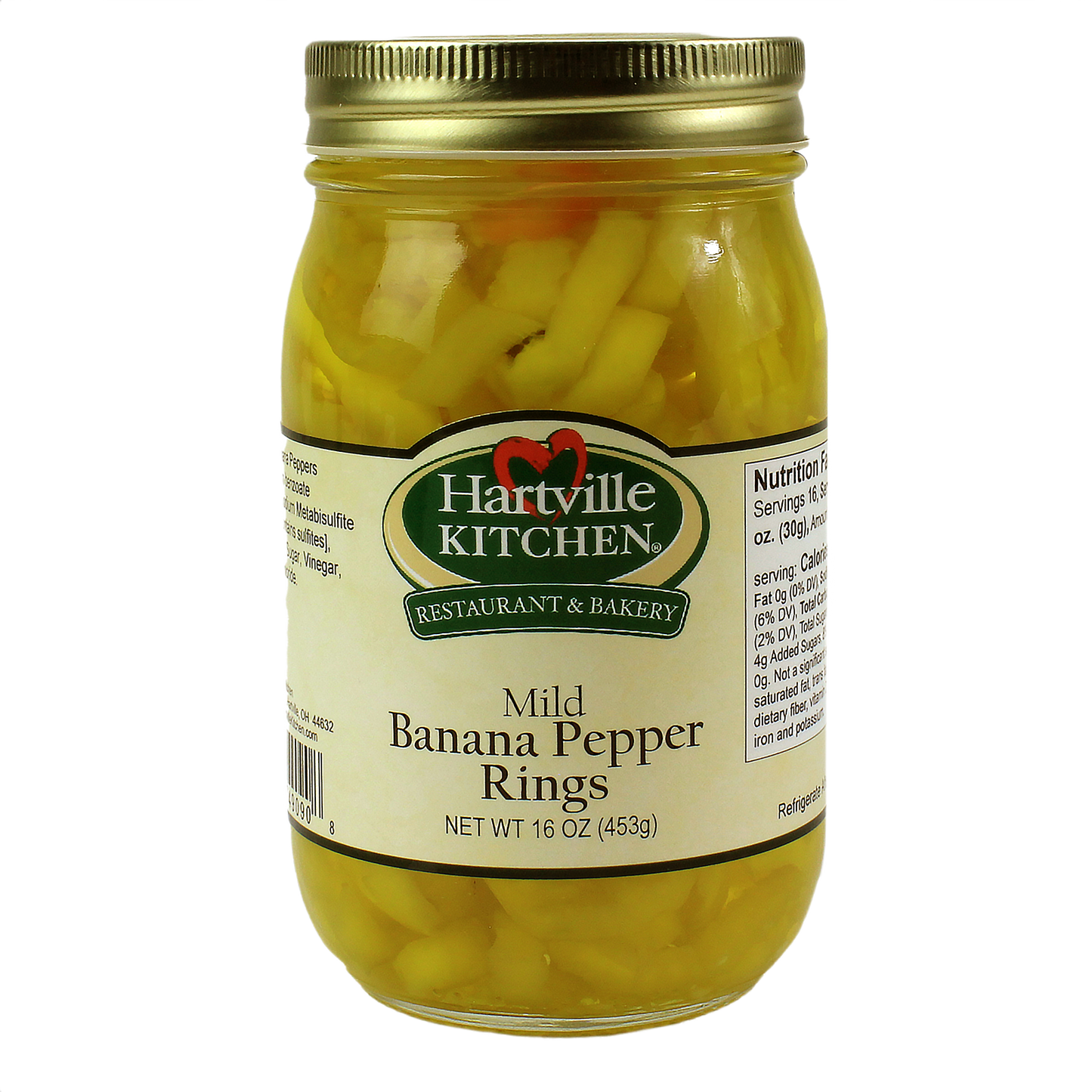 Glass jar filled with mild yellow banana pepper rings preserved in liquid with a gold metal lid