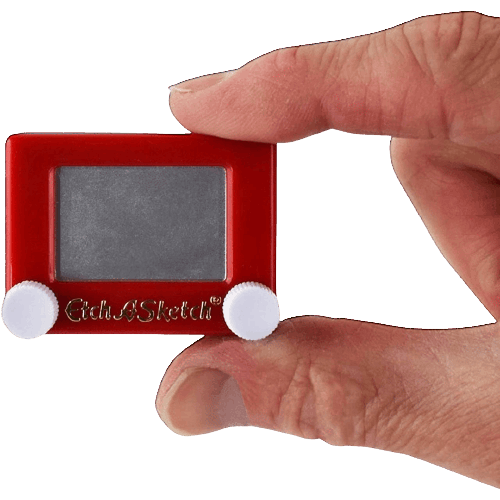 Hand holding a tiny red Etch A Sketch toy with white control knobs for playful drawing and home nostalgia