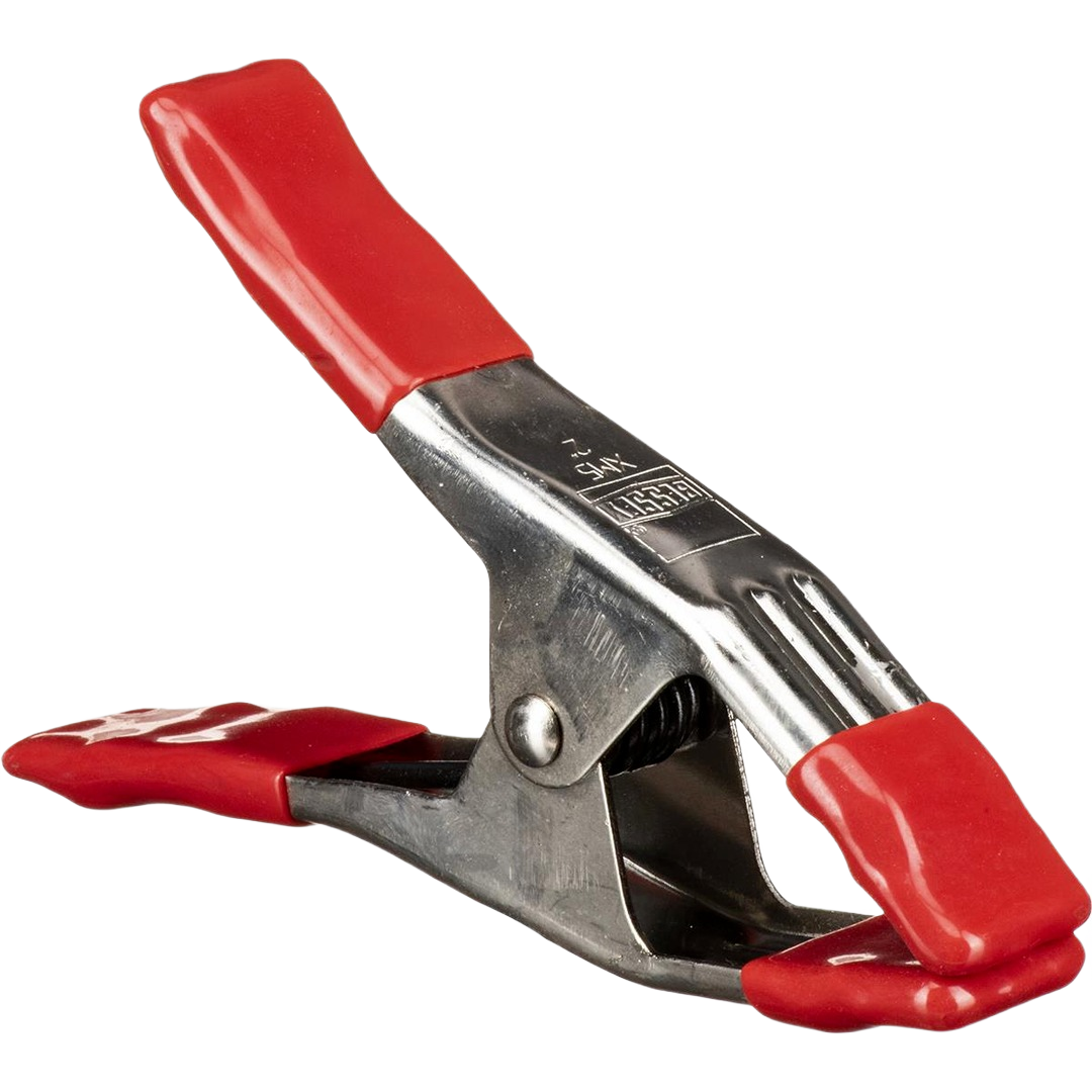 Steel spring clamp with red protective grips designed for secure holding in tools and home improvement projects