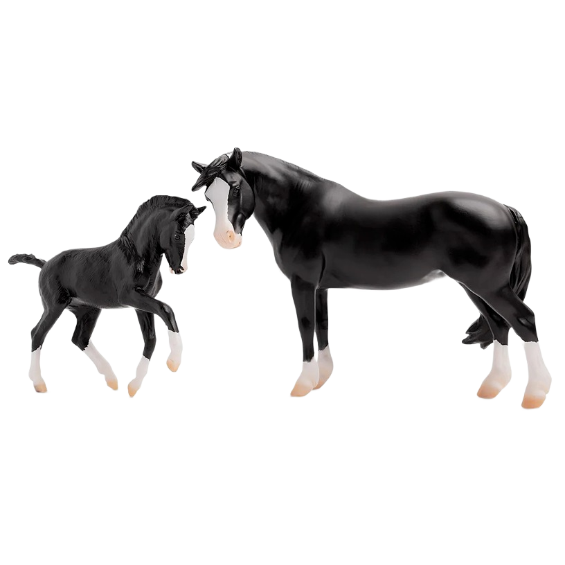 Black and white model Welsh pony mare and foal figures posed side by side on plain background