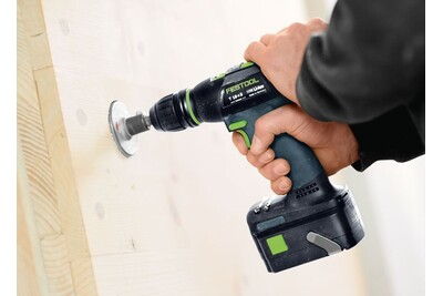 Cordless drill with ergonomic grip drilling into light wood for precision tools and home improvement tasks