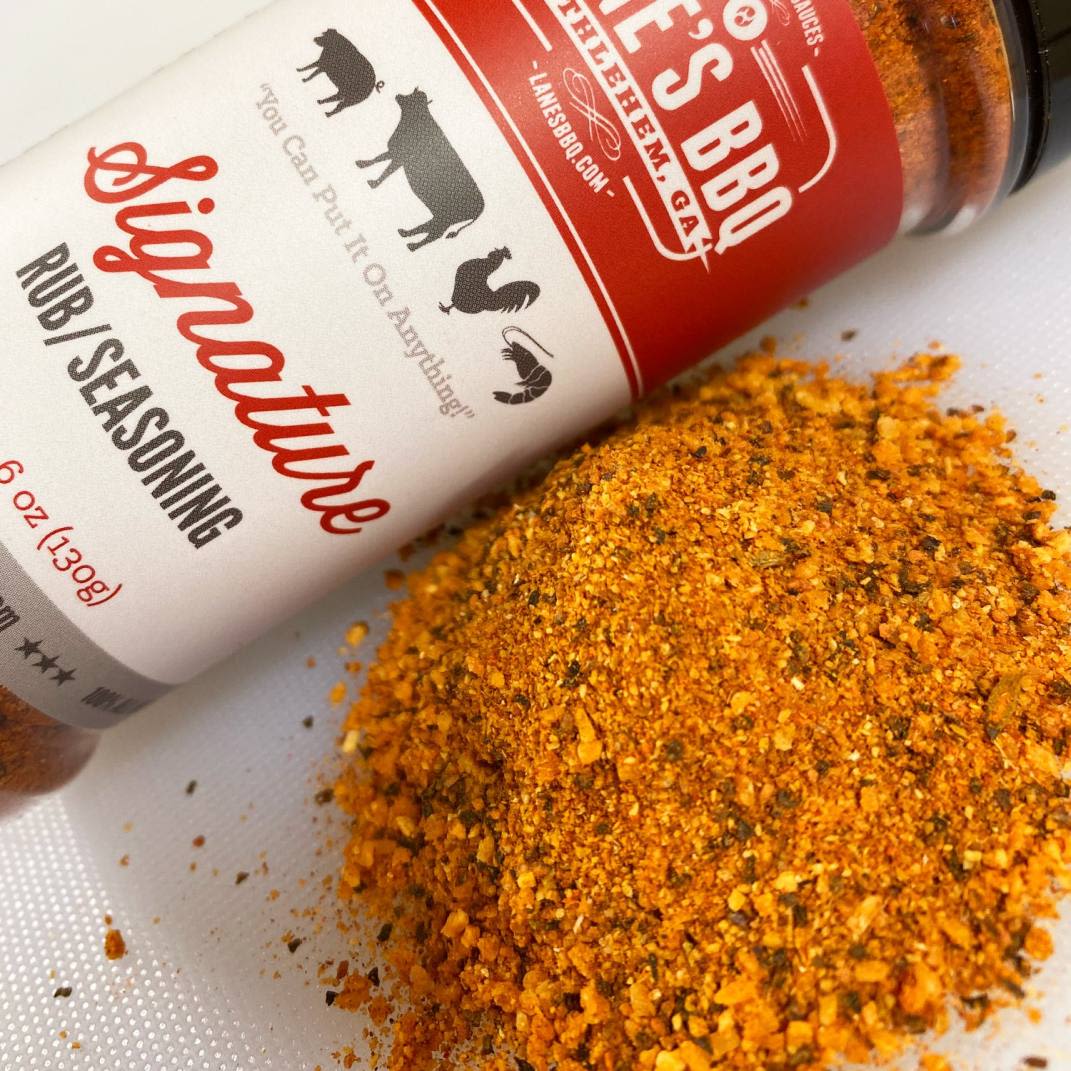 Bottle of Lane’s Signature Rub seasoning with reddish-orange spice blend for grilling and BBQ use