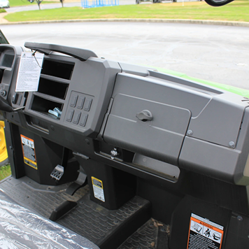 Interior dashboard and storage compartments of a green full-size John Deere utility vehicle for home improvement tasks
