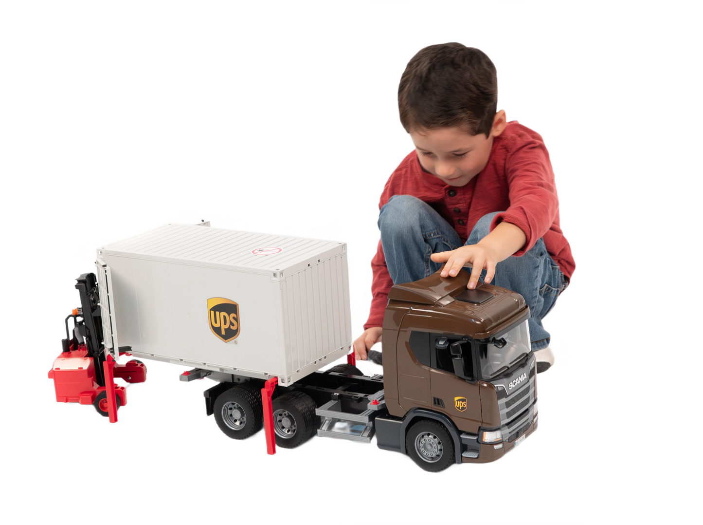Child playing with brown and white UPS logistics toy truck and red forklift from Bruder Toys in Vehicles & Remote Controlled Toys collection