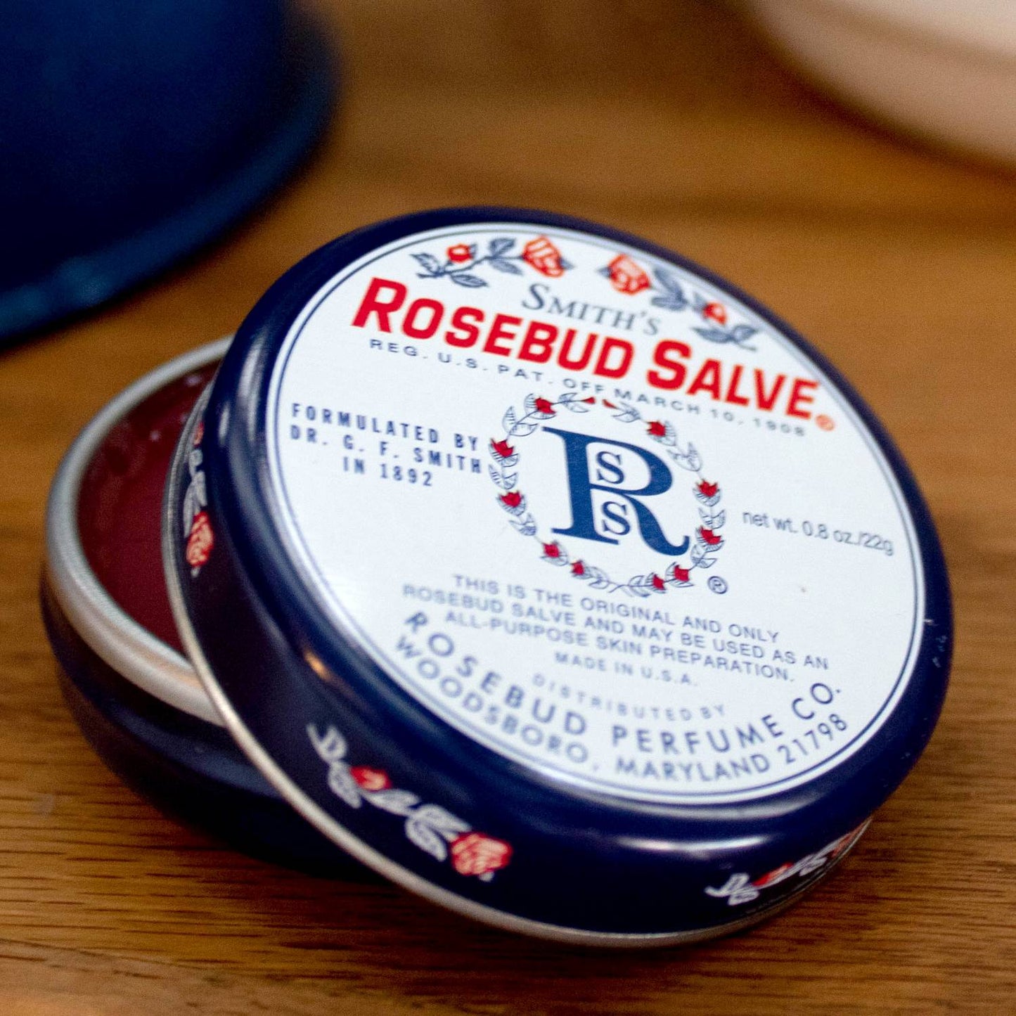 Open navy blue tin of Rosebud Original Salve with vintage floral design in Health & Beauty and Under $25 collections
