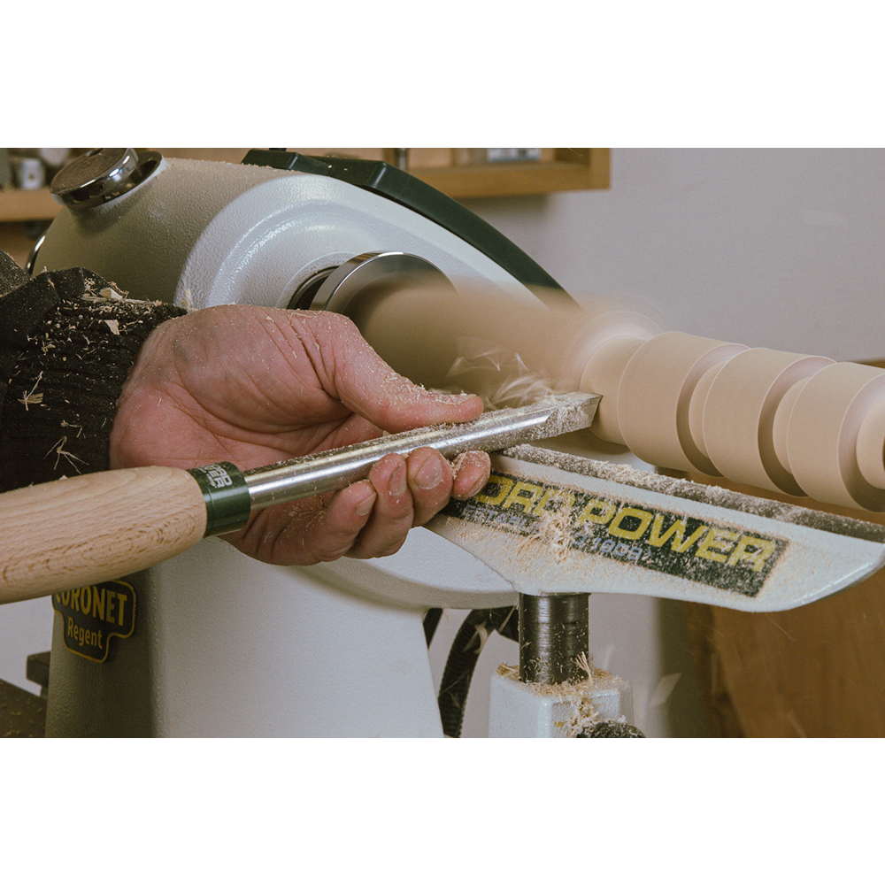 Woodturning tool with carbide tip and wood handle shaping spinning wood on lathe in woodworking tools collection