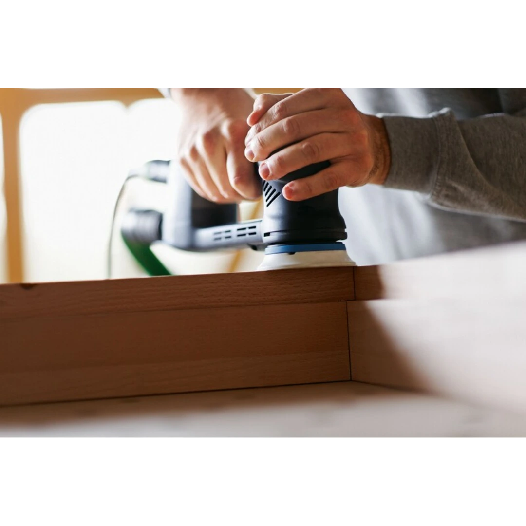 Person using a Festool RO 90 StickFix sanding pad on wooden edge for woodworking tool accessory tasks