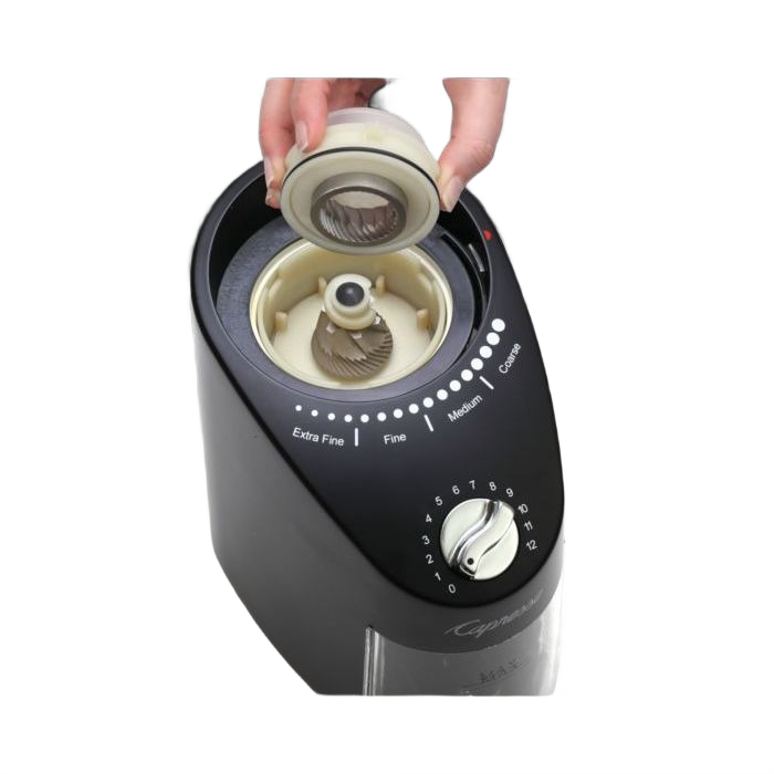 Hand removing capresso burr from black conical burr grinder with grind size dial and indicator settings visible