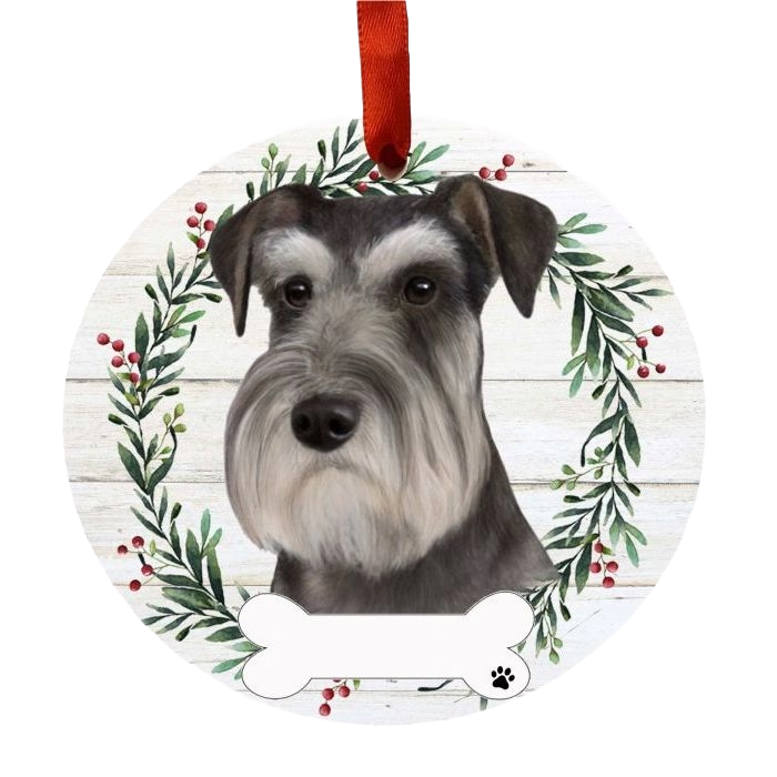 Round Christmas ornament featuring a Schnauzer face with greenery and red berry wreath and red hanging ribbon