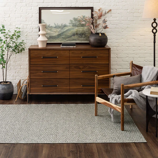 Woven grey area rug with textured pattern placed in modern living room for home improvement decor.