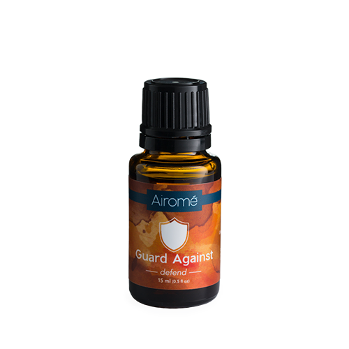 Amber glass bottle of Airome essential oil blend with black cap and shield logo on orange label for home scent use