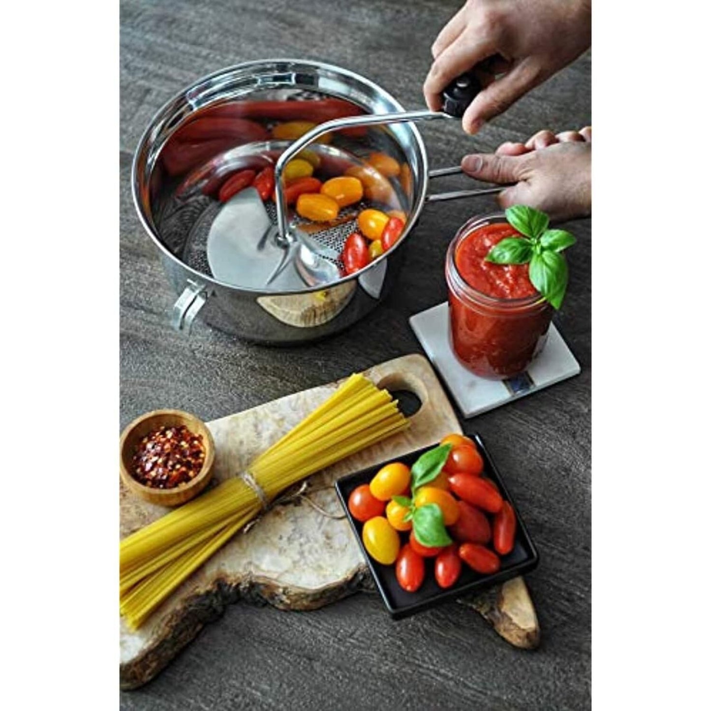 3.5 quart stainless steel food mill crushing cherry tomatoes near pasta and fresh tomatoes in kitchenware collection