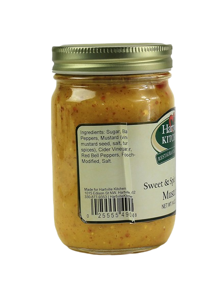 Glass jar of sweet and spicy mustard with gold lid showing ingredient label for kitchen use