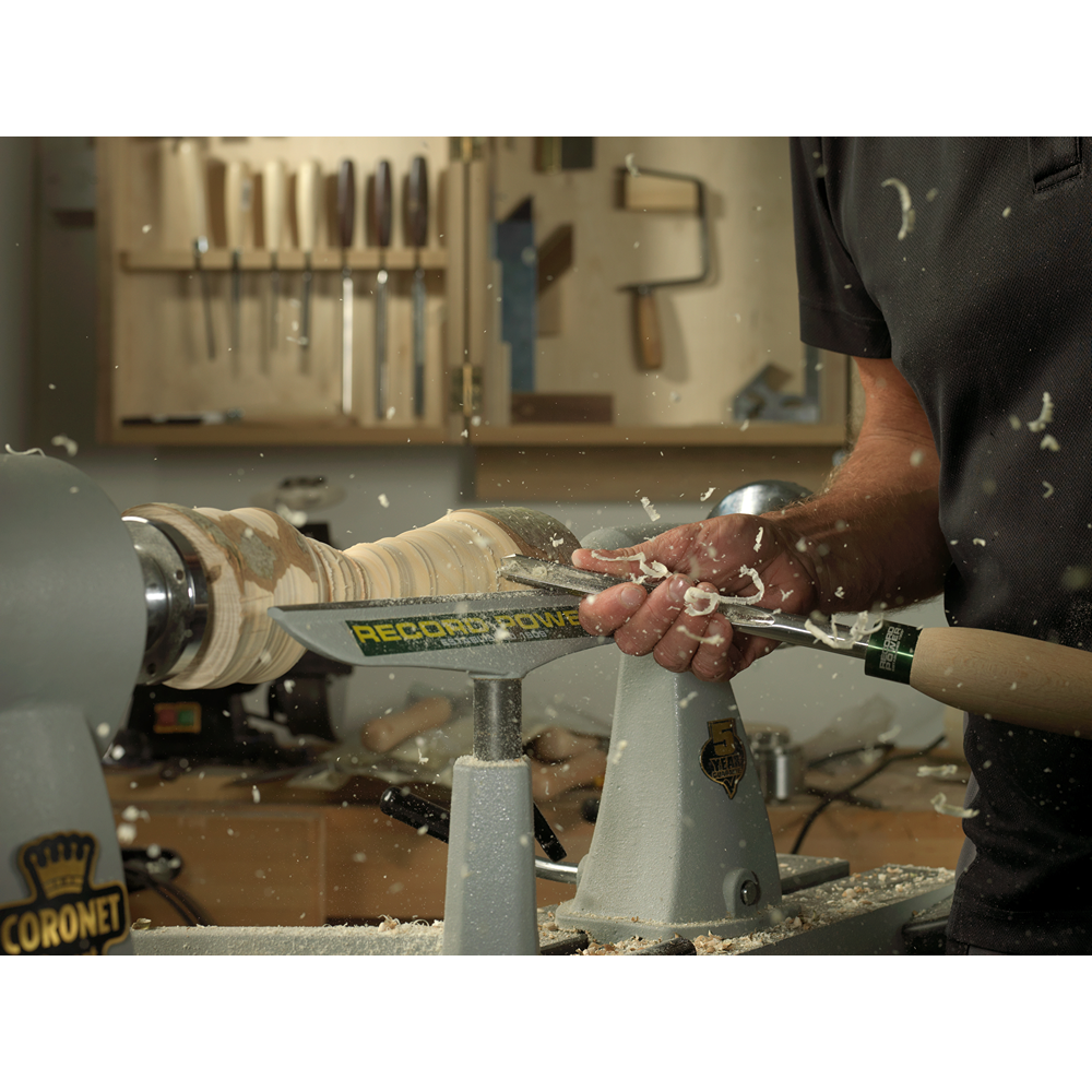 Woodworker shaping wood on a lathe using a high-speed steel spindle gouge in woodworking tools under $100 collection