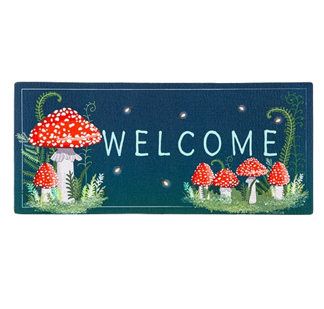 Rectangular welcome mat with red spotted mushroom illustrations and green foliage on dark background
