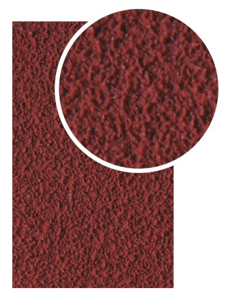 Close-up view of red ceramic abrasive surface with fine grit texture for tools and home improvement use
