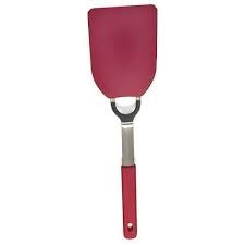 Large red flexible nylon spatula with stainless steel neck and ergonomic handle for kitchen cooking tasks.