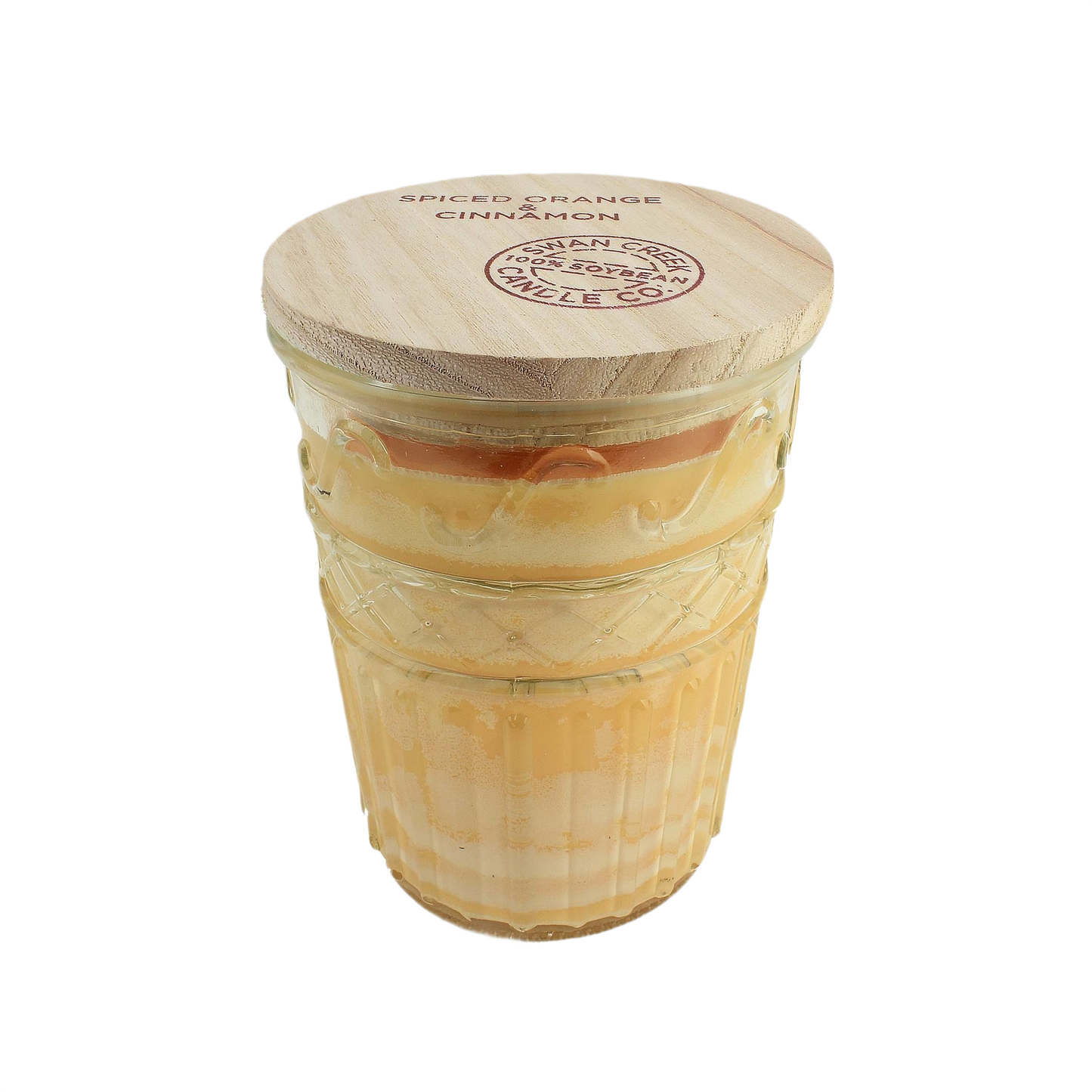 Layered orange and cinnamon scented candle in textured glass jar with natural wood lid for home fragrance.