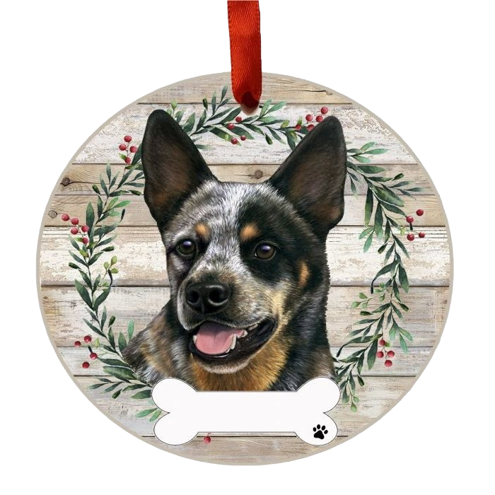 Round wooden Christmas ornament featuring an Australian Cattle Dog face with wreath and red ribbon for hanging