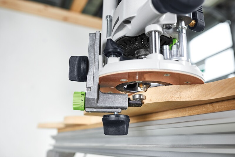 Router angle arm accessory attached to woodworking router guiding precise edge cuts in home improvement project