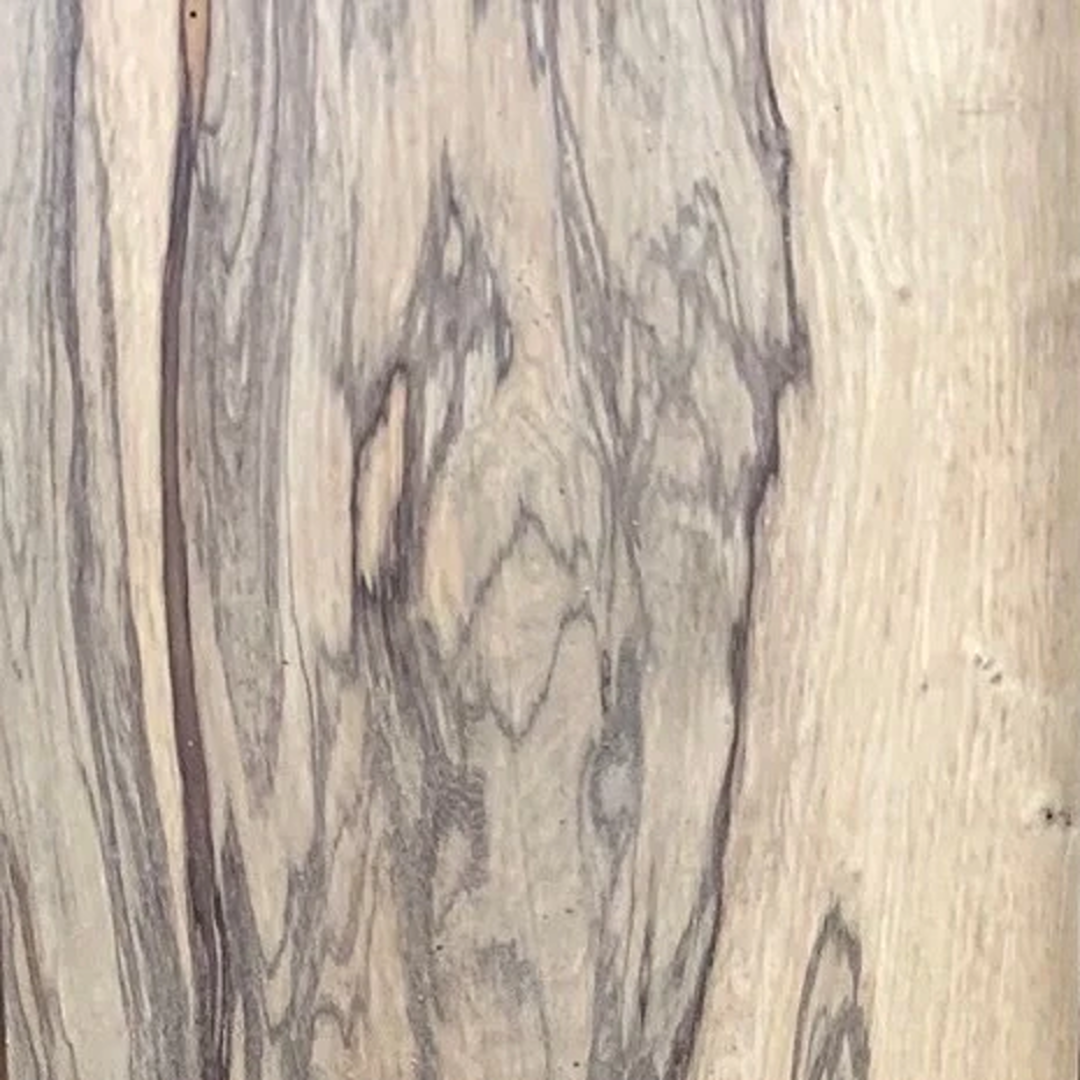 Close-up of exotic lumber with natural black limba wood grain for woodworking and home improvement projects