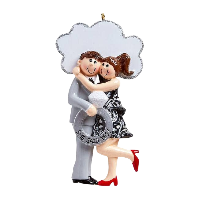 Brunette couple hugging with large engagement ring detail and "She Said Yes!" message from Christmas Ornaments collection