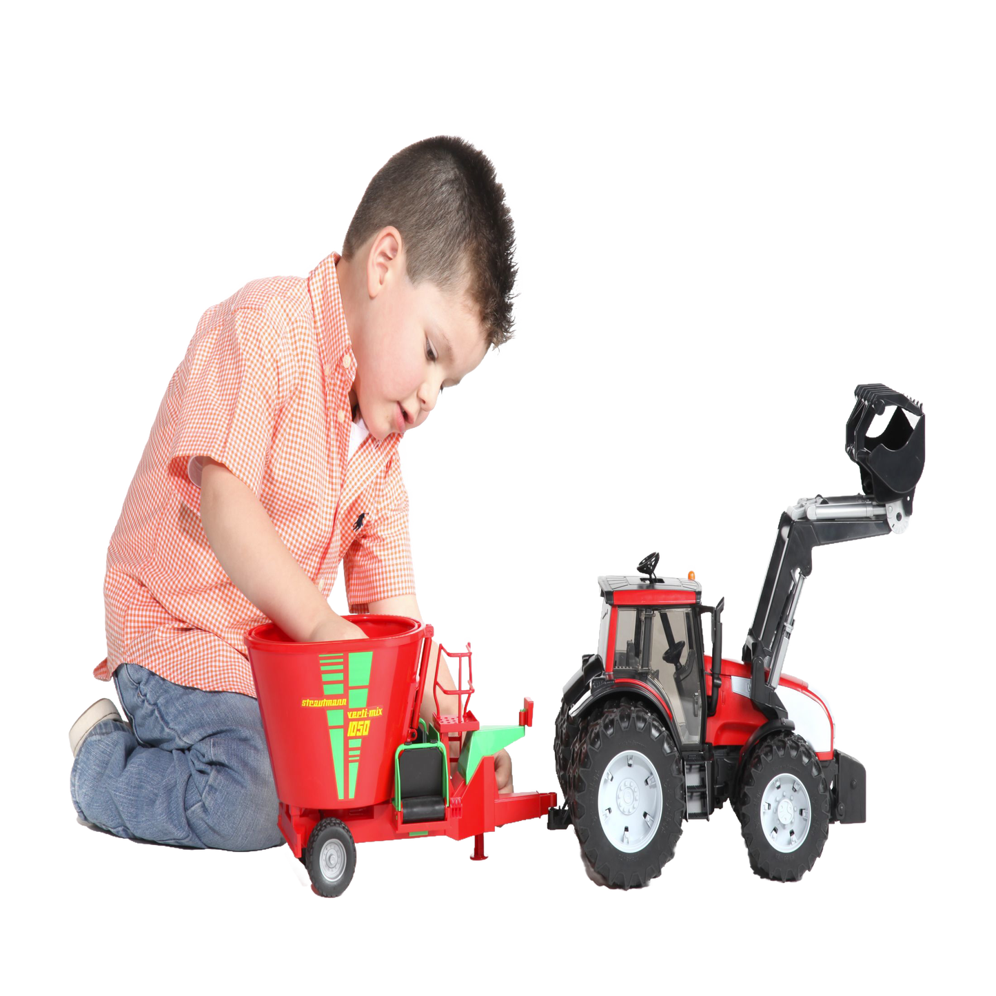 Young boy playing with red and green Bruder 02127 fodder mixer and red tractor in Toys & Games collection