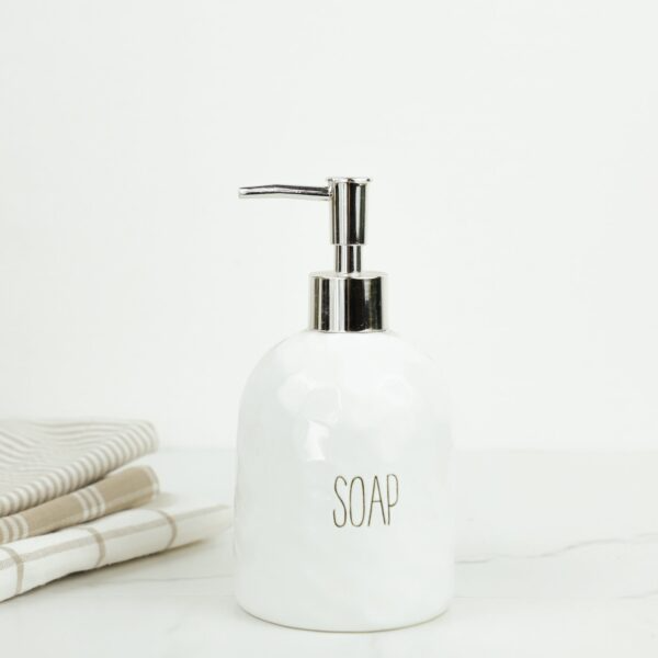 White ceramic soap dispenser with silver pump and minimalist design for home improvement and bathroom use