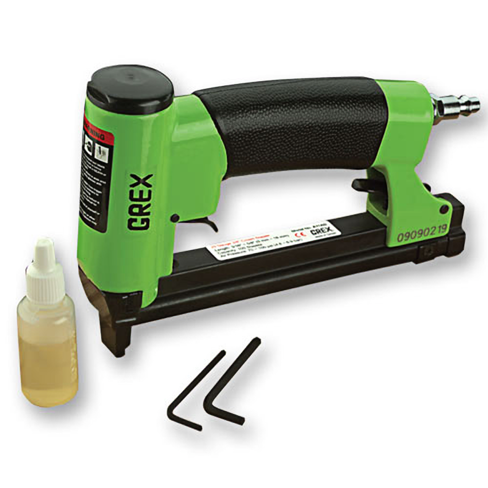 Green and black crown stapler with air connector, oil bottle, and two metal hex keys for home improvement tasks