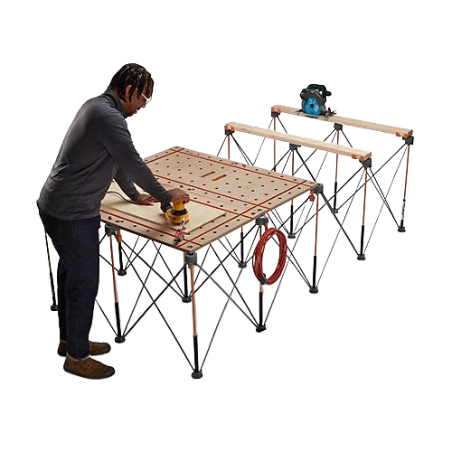 Person using sanding tool on large foldable work surface with adjustable legs and tool support rails for home projects