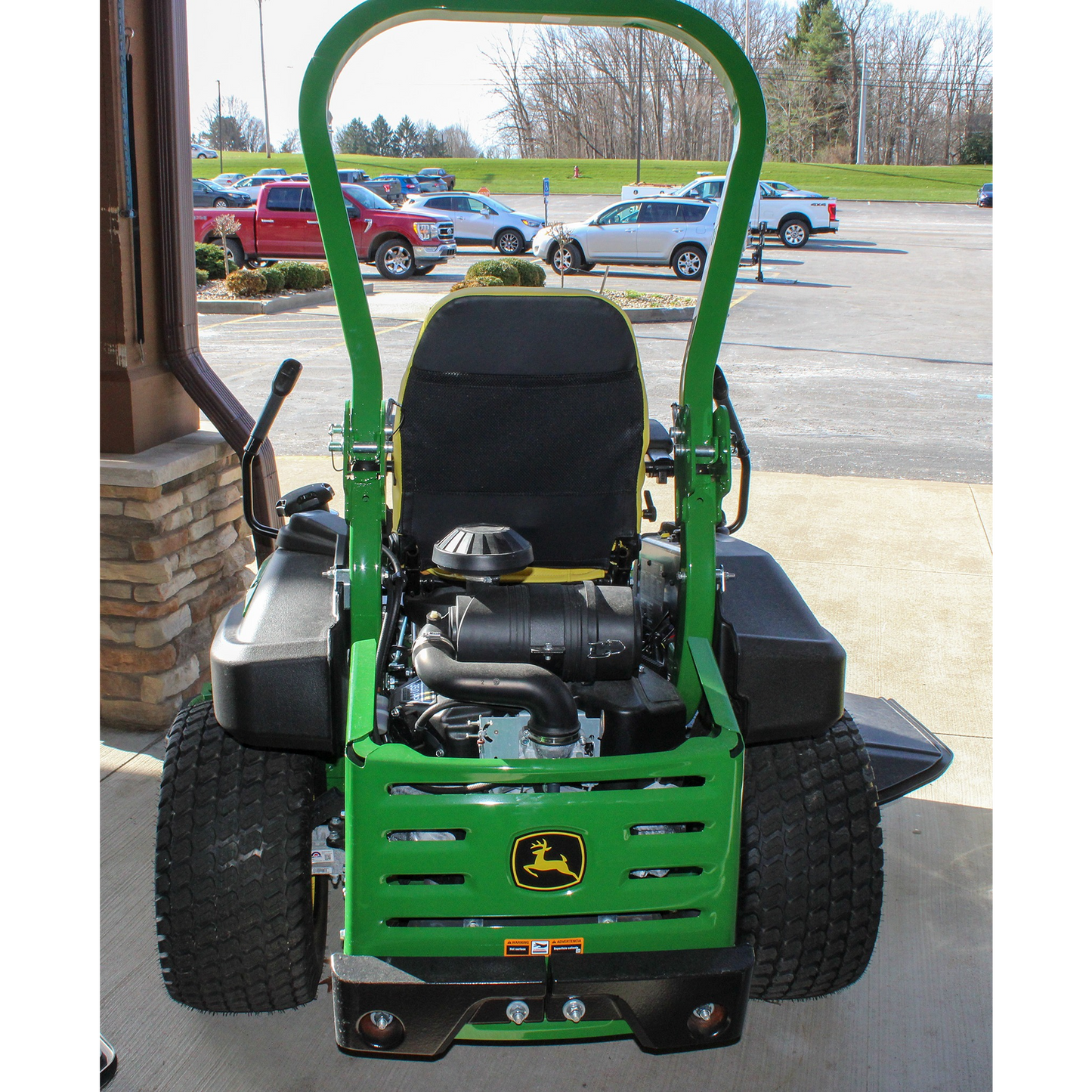 Rear view of a green John Deere zero turn mower showcasing engine and wide rear tires, displayed at Hartville Hardware in lawn and garden equipment.