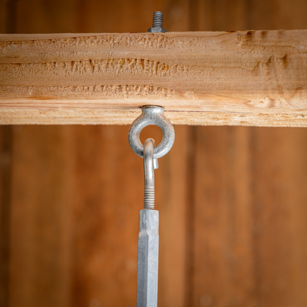 Galvanized eye bolt fastened into wood beam with threaded rod and hook for hardware and home improvement projects under $50