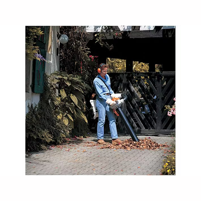 Person using handheld blower with vacuum kit attachment for efficient yard debris collection in home improvement tools collection