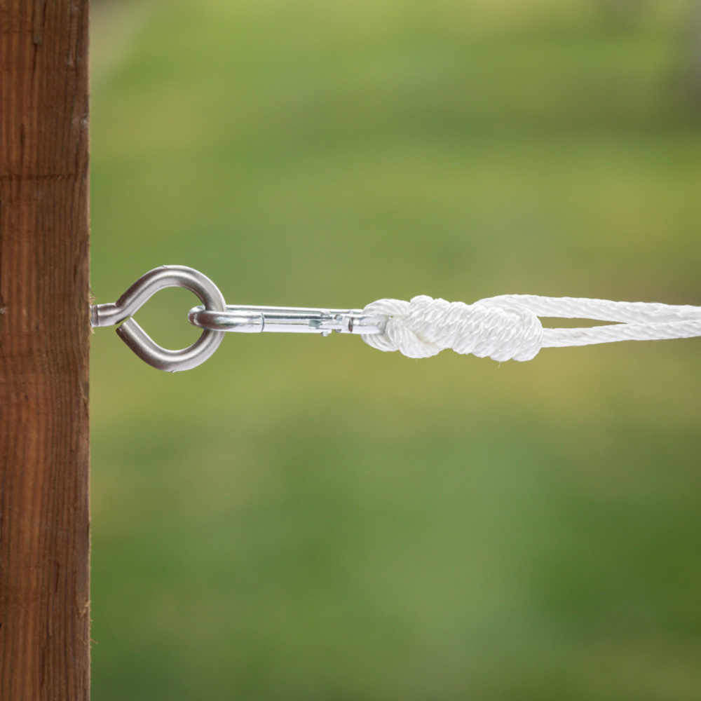 Stainless steel screw eye attached to wood with carabiner and white rope for outdoor fastening in hardware and fasteners collections