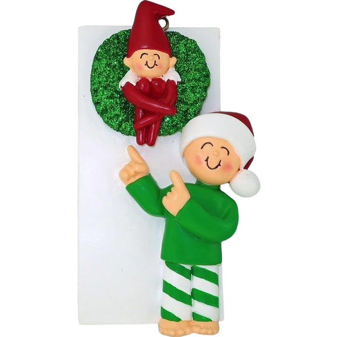 Festive ornament with smiling elf in green pajamas pointing to a red-hatted elf inside a glittery green wreath under $50 Christmas décor