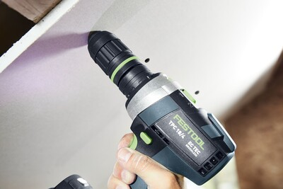 Black and green Festool depth stop chuck attached to a drill for precise woodworking in power tool accessories.