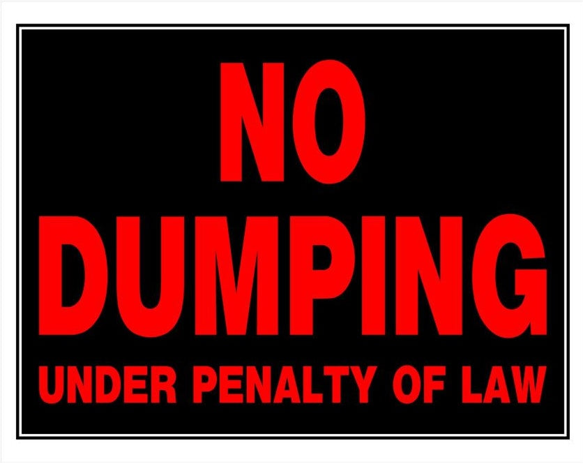 Black plastic sign with bold red lettering stating no dumping under penalty of law for home improvement use