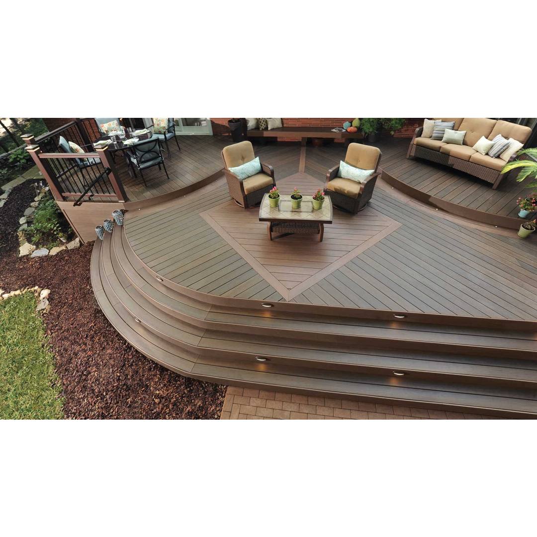 Outdoor deck with mocha-colored riser boards and seating area featuring modern patio furniture in home improvement setting